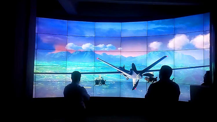 An unmanned aerial vehicle (UAV) demonstrated on a video wall.