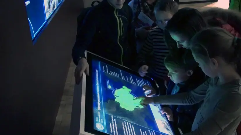 Visitors of the Festival are managing an interactive map at the touch kiosk.